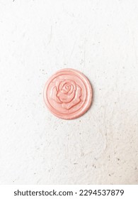 Soft pastel metallic pink rose pattern wax stamp or wax seal coin on a white background. Can be use for vintage antique wedding invitation or decoration - Shutterstock ID 2294537879