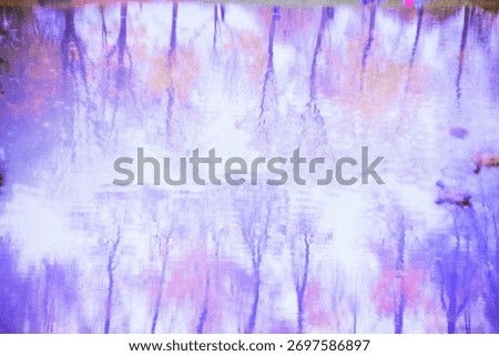 Soft pastel reflection of trees in water, creating a dreamy abstract composition in violet and pink tones. Gentle ripples distort the reflection for a painterly, ethereal effect.