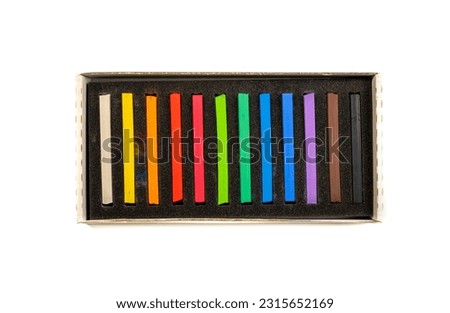 Soft pastel set in a box, top view. Isolated on white background. Since most soft pastels made from natural pigments, they are one of the more expensive art supplies available.