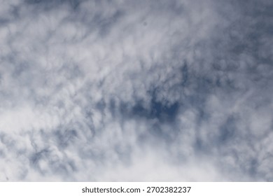 Soft patterned clouds stretching across the sky, creating a textured and atmospheric cloudscape with gentle light and natural tones.