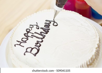 Soft Photo Of Cake Decorating Using Piping Tip For Writing A Word