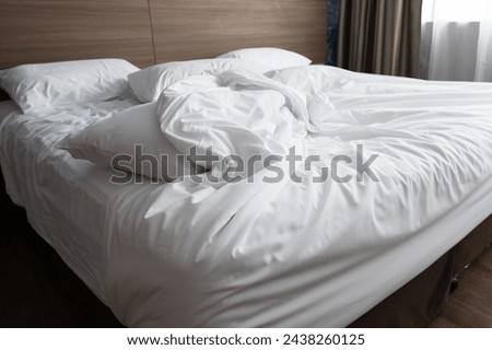 Similar – Image, Stock Photo Unmade bed with pillows and crumpled bedsheets and open laptop