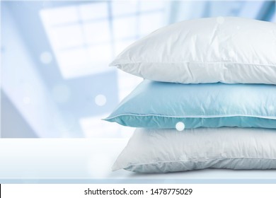 Soft Pillows Pile on grey background, three pillows, sleeping items.