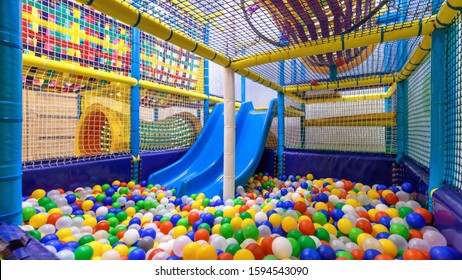 Soft play area indoor, plastic gym in playroom. Kids playground for sport, panorama inside dry pool or ball pit and slide. Empty colorful play area for children. Entertainment theme. - Shutterstock ID 1594543090