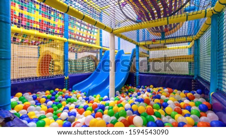 Soft play area indoor, plastic gym in playroom. Kids playground for sport, panorama inside dry pool or ball pit and slide. Empty colorful play area for children. Entertainment theme.