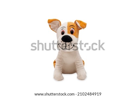 Soft plush toy dog looking cute straight into the camera. Cute dog doll isolated on white background.