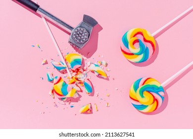 Soft Pop Lollipops On Pastel Pink Background, Top View. Broken With Hammer Candy. Sugar Detox, Healthy Eating And Junk Food Concept.