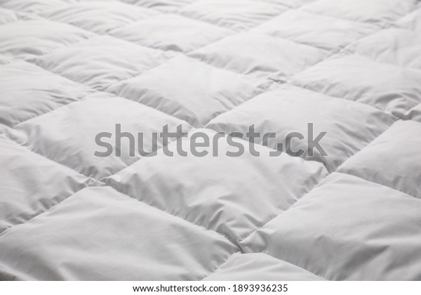 Soft quilted
blanket as background, closeup
view