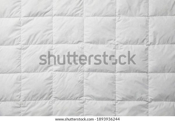 Soft quilted\
blanket as background, top\
view