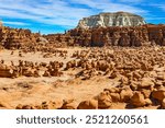 Soft red-brown sandstone and the prairie wind have created thousands of mushroom-shaped hoodoos. Picturesque park in Utah. Goblin Valley in the USA. 