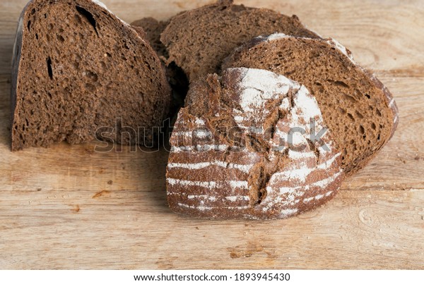 soft rye bread with a crisp crust, fresh and\
delicious rye bread made from rye flour , divided into parts, rye\
fresh loaf of bread