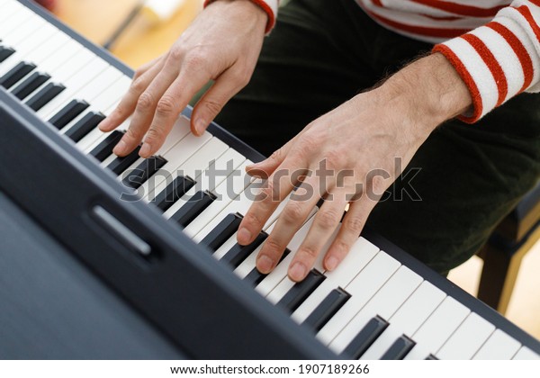 soft selective\
focus, european, caucasian man playing the piano. Music lesson,\
musician, pianist, love\
music