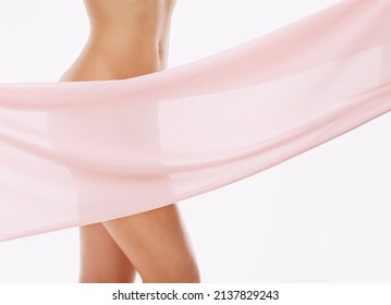 Soft and sensual. Cropped studio shot of pink material masking a womans naked body.