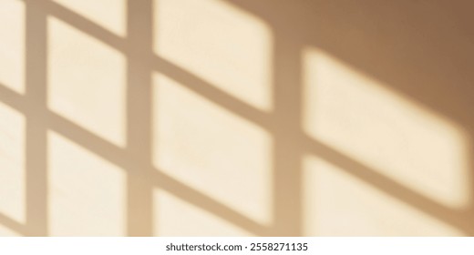 Soft shadows creating geometric patterns on a warm wall.