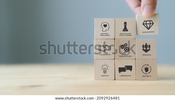 Soft skills concept. Used for presentation,\
banner. Hand puts wooden cubes with icons of \