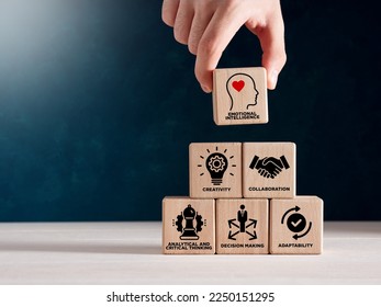 Soft skills HR concept. Hand puts wooden cubes with icons of soft skills, emotional intelligence, creativity, collaboration, adaptability, decision making and analytical thinking.