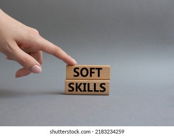 Soft skills symbol. Wooden blocks with words Soft skills. Beautiful grey background. Businessman hand. Business and Soft skills concept. Copy space.