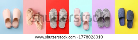 Soft slippers on color background