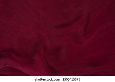 Soft Smooth Burgundy Silk Fabric Background. Fabric Texture. 