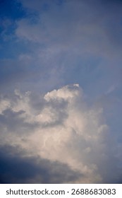 Soft sunlight filters through dense gray clouds, a calm transition from warm light to brooding evening.
