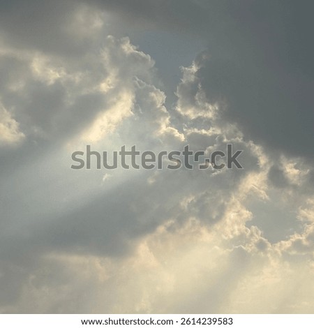 Soft sunlight piercing through moody clouds