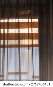 Soft sunlight streaming through sheer curtains highlights the beauty of a cozy interior, creating a serene atmosphere in a home environment during daytime.