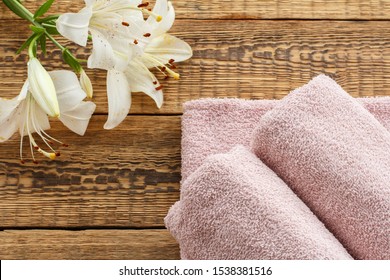 Soft Terry Towels With Bouquet Of White Lily Flowers On Wooden Boards. Top View.