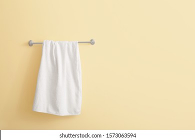 Soft Towel Hanging On Color Wall