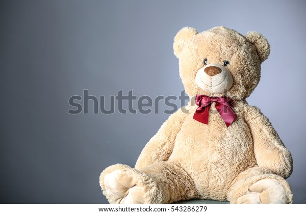 brown teddy bear with red bow tie