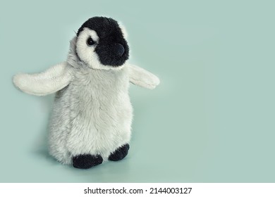 soft toy penguin on blue background 