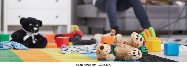 Soft toys laying on the floor in living room interior