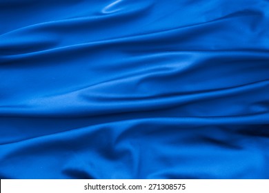 Soft velvet piece of blue fabric with folds to be used as background