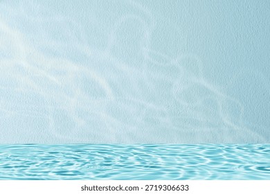 Soft water caustics light reflection on a minimal blue wall with empty copy space. Clean abstract background suitable for summer design, skincare branding, wellness concepts,and modern website layouts