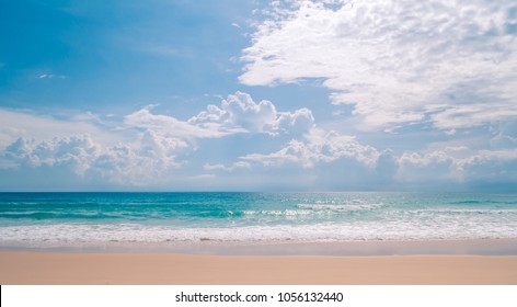 Soft wave of blue ocean on sandy beach in summer season. Background with blue sky and sun daylight relaxation landscape viewpoint