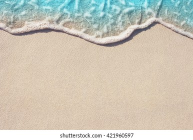 Soft Wave Of Blue Ocean On Sandy Beach. Background. Selective focus.