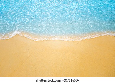 Soft wave of blue ocean on sandy beach. Background. - Shutterstock ID 607616507