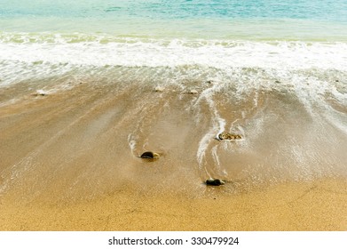 Soft wave of the sea on the sandy beach - Shutterstock ID 330479924