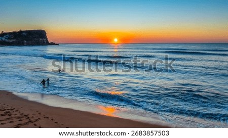 Soft waves roll ashore beneath a blush-toned sky, as sunrise unfurls over Avalon Beach on Sydney’s Northern Beaches.