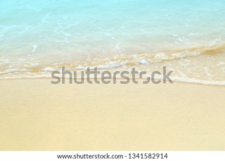 Soft white blue sea wave on clean brown sandy beach coast have copyspace