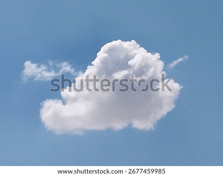 
A soft white cloud in the middle of the clear blue sky, giving the scene a sense of calm and serenity.