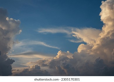 Soft white clouds adorn the blue sky, creating a calming scenery.