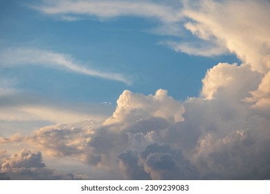 Soft white clouds adorn the blue sky, creating a calming scenery.