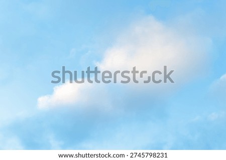 Soft white clouds drift in clear blue sky. Mild daylight casts gentle glow on cloud forms. Clouds float freely, creating serene, tranquil atmosphere. Sky's subtle gradient enhances peaceful