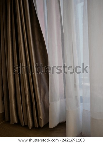 Soft white curtains are simple yet elegant for graphic design or wallpaper. Blurred cloth pattern with luxurious texture.