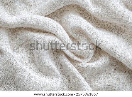 Soft white fabric draped elegantly showcasing a textured, lightweight weave perfect for various crafts and designs