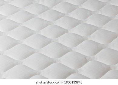 Soft white mattress close-up background with selective focus.