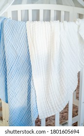 Soft White Muslin Blanket Hanging On A Child's Bed Closeup