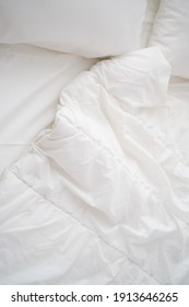 Soft White Pillows On Messy Bed, Closeup
