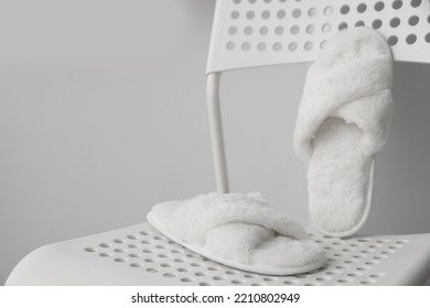 Soft White Slippers On Chair, Space For Text