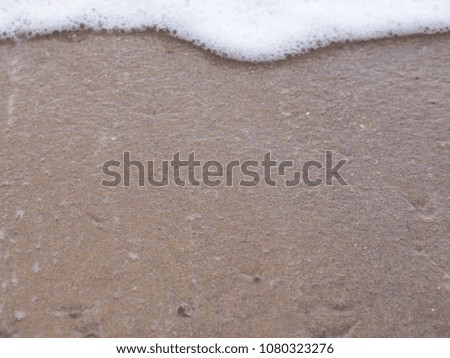 Soft white wave of  sea on sandy beach. background. 
